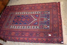 A red ground rug, approx 153cm long