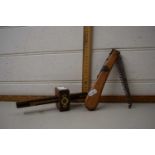 A folding pocket wooden handled tree saw and a wooden and brass gauge