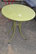 A green metal bistro table