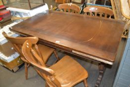 An extending dining table together with four pine kitchen chairs