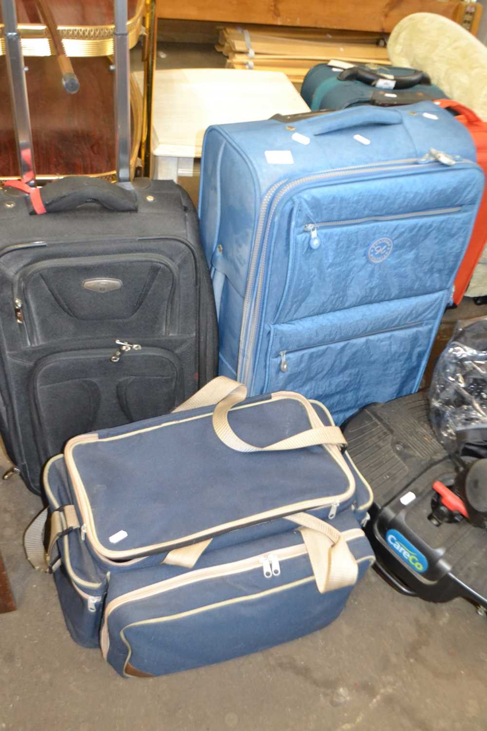 Two suitcases and a blue canvas picnic hamper