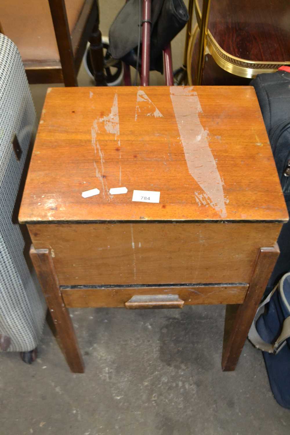 A freestanding sewing box with lift up lid and drawer below