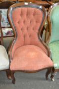 A buttoned shield backed mahogany framed chair with russet coloured upholstery