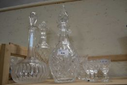 Four glass decanters with stoppers and a quantity of liqueur glasses