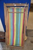 Two wooden framed folding deckchairs