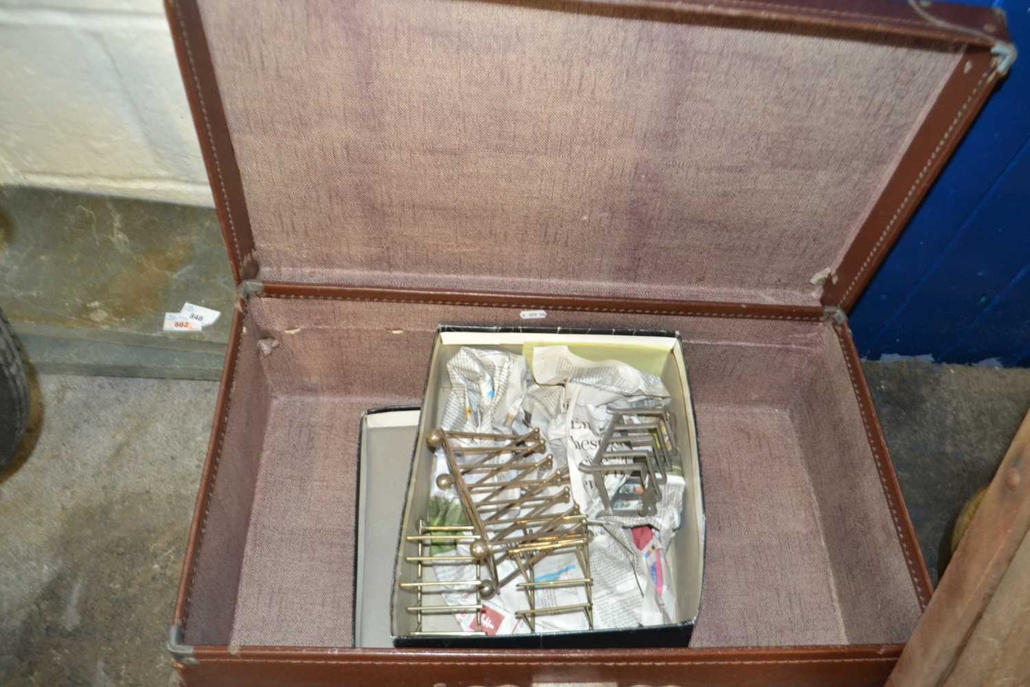 Four metal toast racks (one possible Christopher Dresser) together with a vintage suitcase