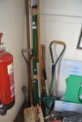 Quantity of assorted gardening tools to include shovels, rakes, pick axe etc