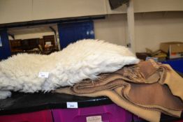 Sheepskin rug together with a reversible throw