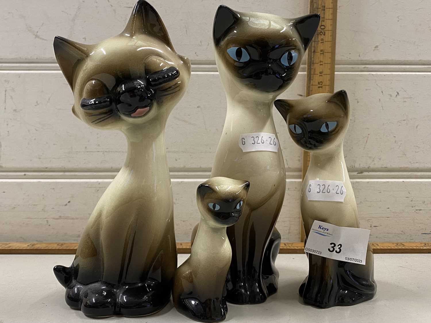 Four various pottery cats