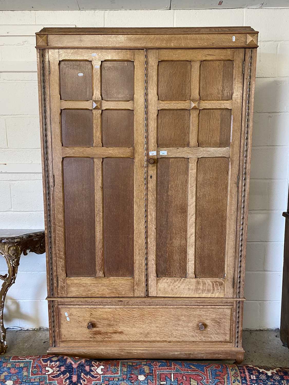 A oak double fronted wardrobe with two doors and drawer below, 119cm wide