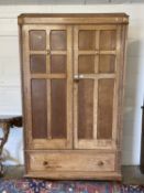 A oak double fronted wardrobe with two doors and drawer below, 119cm wide