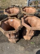 Set of four octagonal terracotta urns or planters, 38cm wide, 50cm high