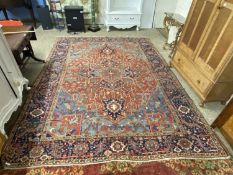 Large Middle Eastern wool floor rug decorated with a central red panel. Approx 2.7m x 3.7m.Carpet