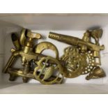 Box of various brass barrel taps, horse brasses and other items