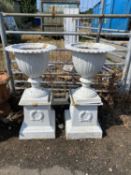 Pair of cast iron urns and accompanying pedestals with white painted finish, 90cm high, total urn