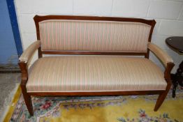 An oak framed open armed sofa with pink and green striped upholstery, approx 153cm wide