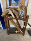 Stick stand containing vintage rackets, hockey sticks, croquet mallets etc