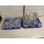 Two trays of various drinking glasses, decanters and other assorted items