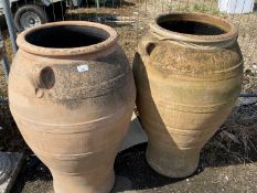 A near pair of large terracotta olive type jars, 90cm high