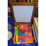 Child's set of building blocks and a folding drawing board