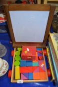 Child's set of building blocks and a folding drawing board