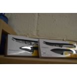 Two boxed cheese knife sets