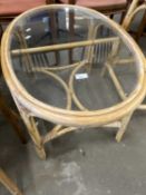 An oval glass topped conservatory table