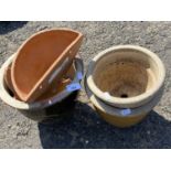 Three stone ware planters together with a pair of terracotta wall pockets