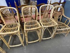 A bamboo conservatory elbow chair together with three similar bar stools