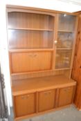 Mid to late 20th Century cabinet with glazed cupboard and shelves and drop down flap above with