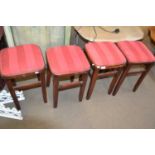 Set of four kitchen stools with upholstered red tops