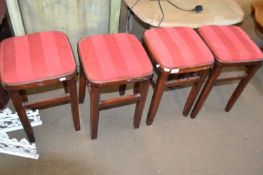 Set of four kitchen stools with upholstered red tops