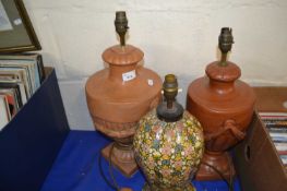Two pottery urn style table lamps together with a floral decorated papier mache lamp (3)