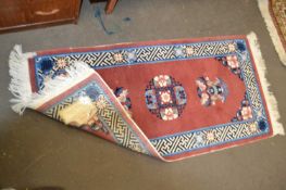 Chinese rug, pink ground, approx 121cm long