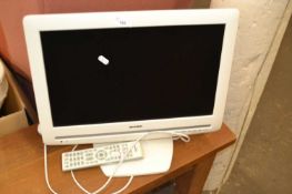 Toshiba white framed TV and remote control