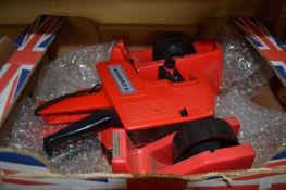 Box of various code guns and tape reels