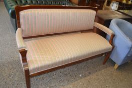 An oak framed open armed sofa with pink and green striped upholstery, approx 153cm wide