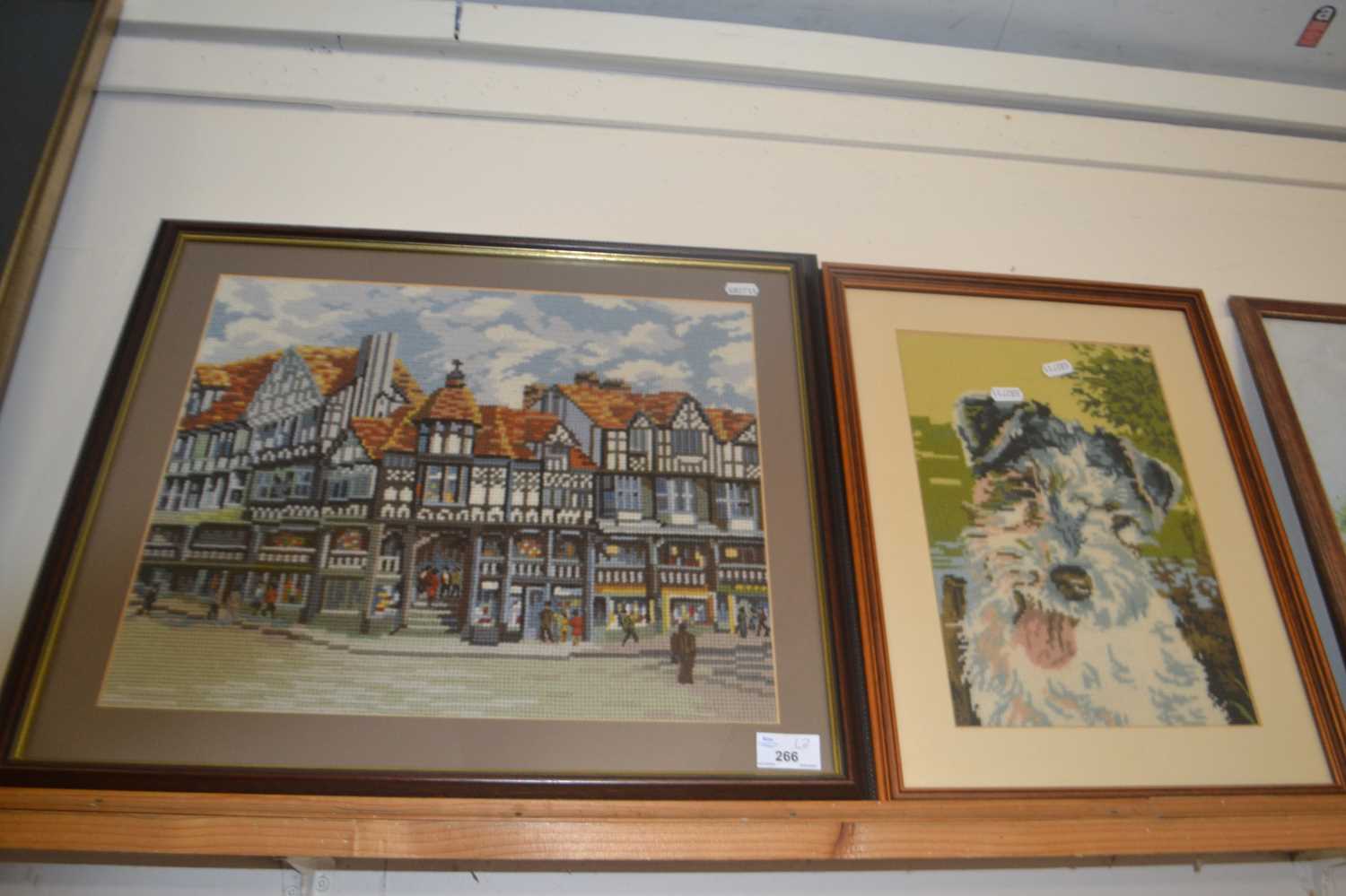 Two tapestry pictures, street scene and a terrier, framed and glazed (2)