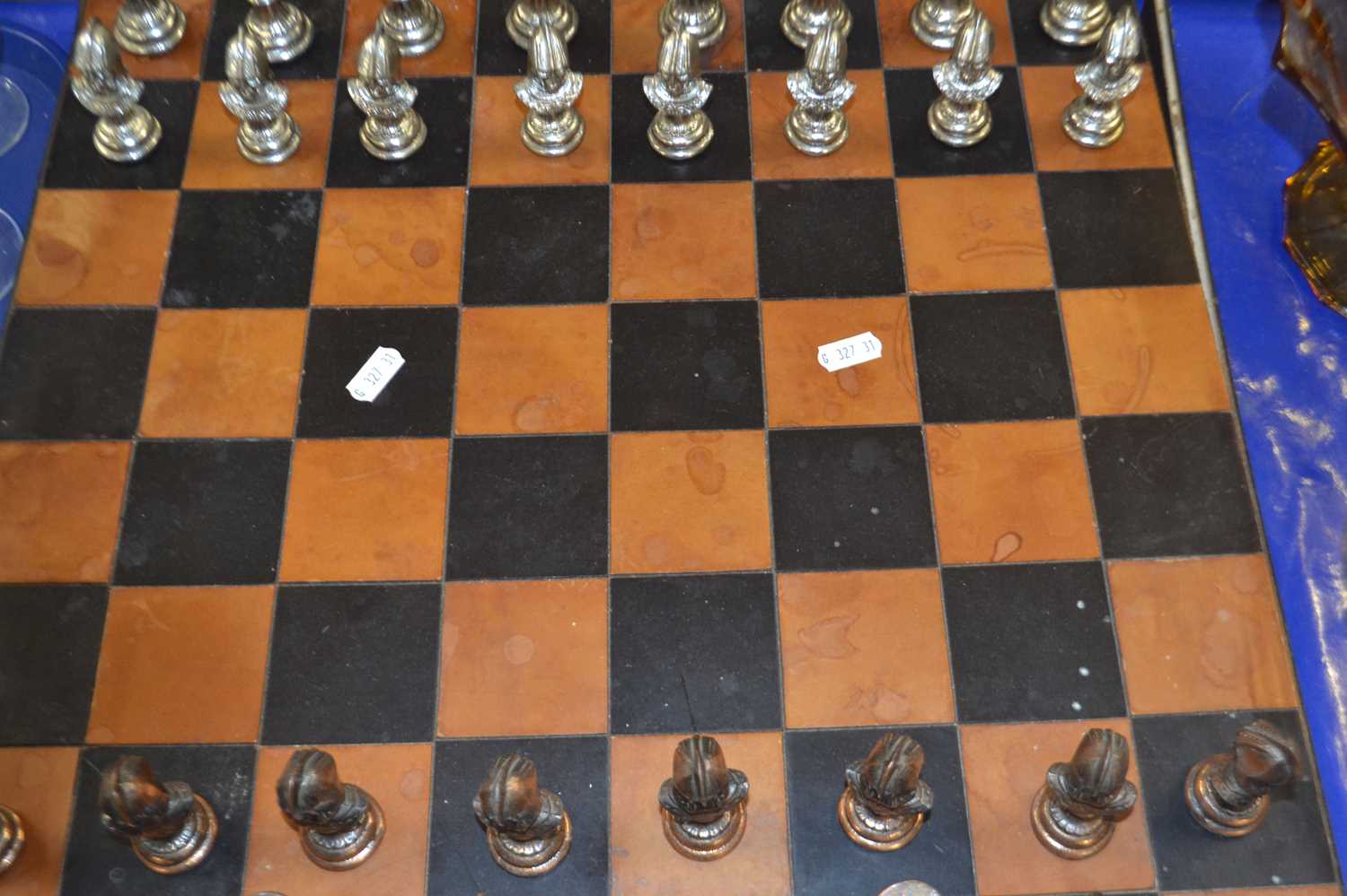 Modern metal chess set and accompanying board