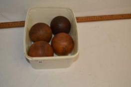 Four wooden balls