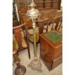 Victorian brass oil lamp raised on a ribbed three footed pedestal