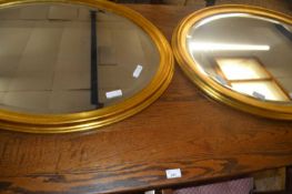 Pair of modern oval bevelled wall mirrors in gilt finish frames, 80cm wide