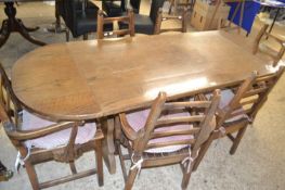 Modern oak drop leaf dining table with a set of six ladder back dining chairs