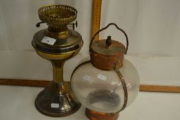 Brass oil lamp base together with a further copper mounted hanging lamp