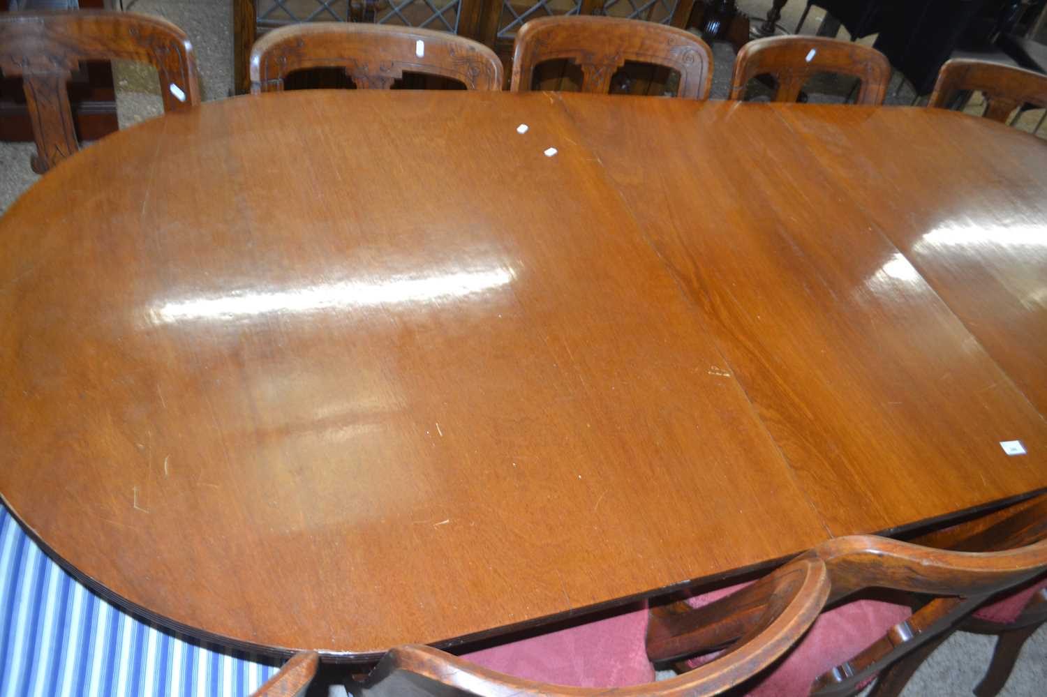 Reproduction mahogany veneered twin pedestal dining table together with a harlequin set of eleven