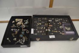 Two display cases containing various earrings and costume jewellery