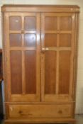 A oak double fronted wardrobe with two doors and drawer below, 119cm wide
