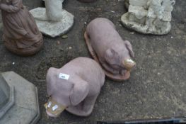 Two pink painted terracotta pigs