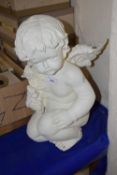 Cream painted model of a seated cherub holding a bouquet of roses