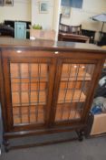 Three tier glazed display cabinet with lead glass doors